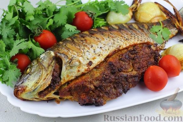 Запечённый карп, фаршированный икрой и луком